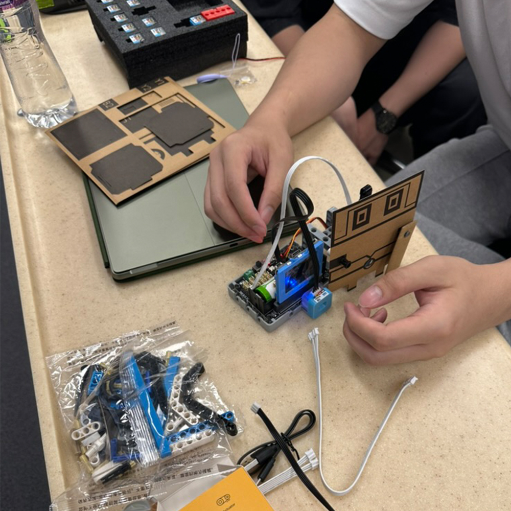 Close-up of illuminated circuit board with microcontrollers and sensors for IoT prototyping