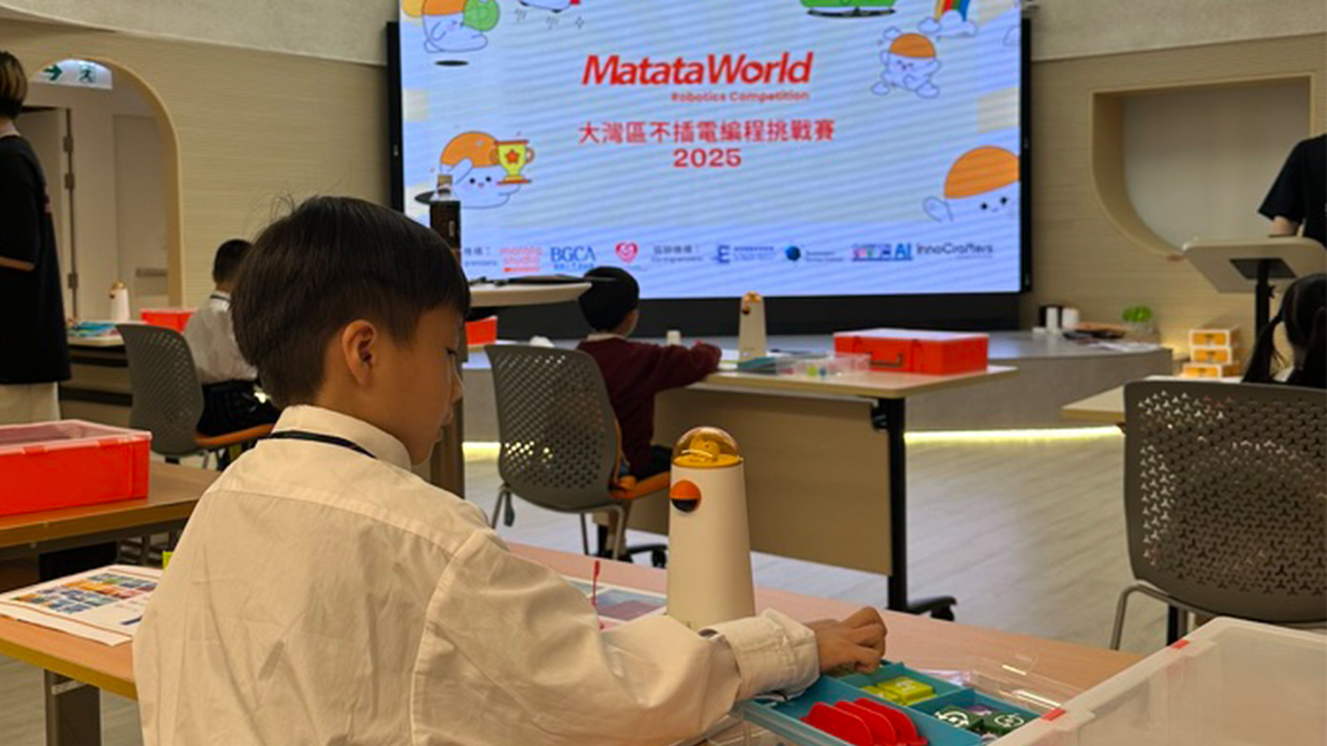 students intensely focused on a complex robotics competition arena with colorful obstacles and high-precision mechanical parts