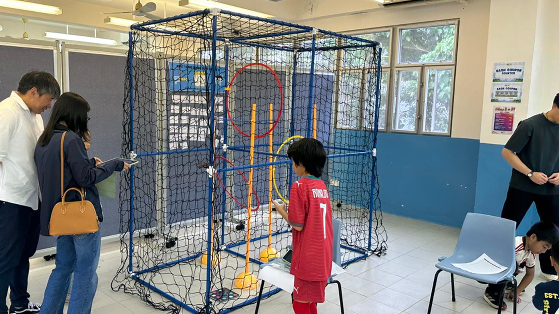 a bustling school open day event with vibrant STEAM displays, interactive digital screens, and curious parents and students